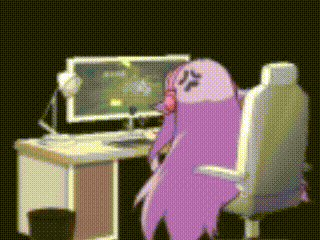 a purple cartoon character is sitting at a desk with a computer .
