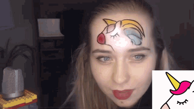 a woman has a unicorn painted on her face