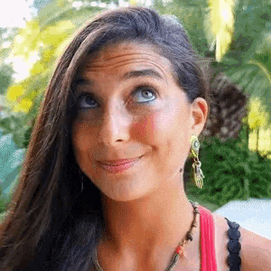 a close up of a woman 's face with a slight smile on her face