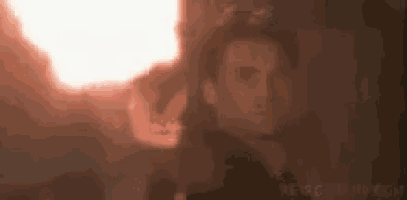 a close up of a person 's face with a red light coming out of his mouth .