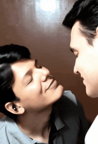 a man and a woman are looking at each other