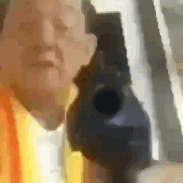 a blurry picture of a person holding a gun .