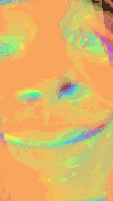 a close up of a person 's face with a rainbow of colors
