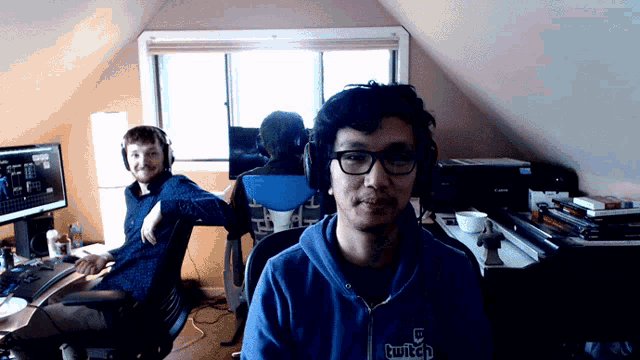a man wearing a blue hoodie that says twitch on it