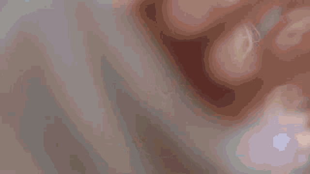 a close up of a woman 's face with a blurred background .