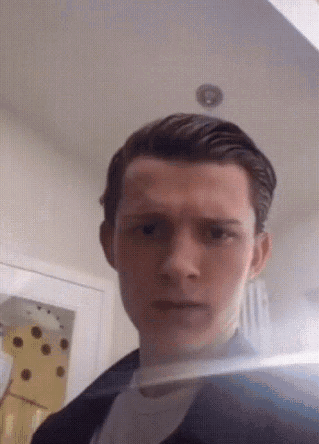 a close up of a man 's face with a reflection of him in a mirror