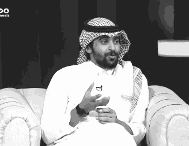 a man is sitting on a couch with the word channels on the bottom