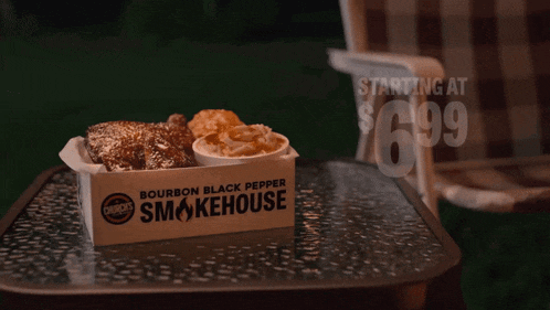 a box of bourbon black pepper smokehouse chicken sits on a glass table