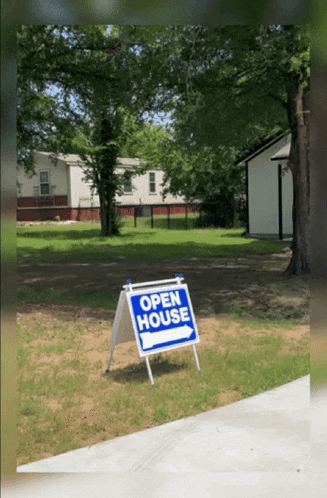 a blue open house sign with a white arrow pointing to the right