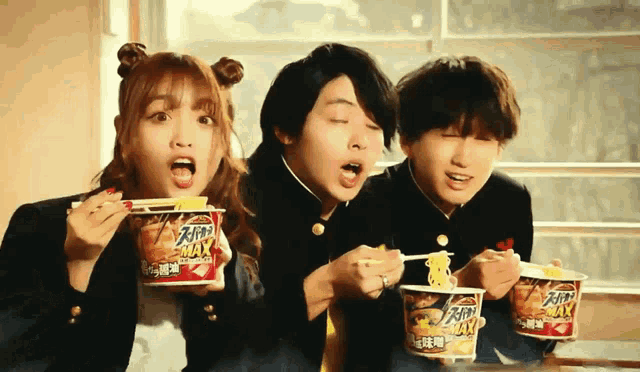 three people are eating noodles from cups that say " max "