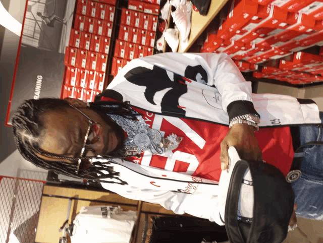 a man in a red and white shirt with the number 23 on it
