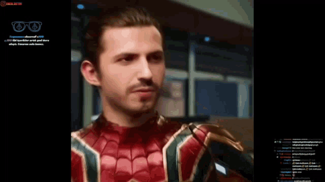 a screen shot of a man in a spiderman costume with glasses on it