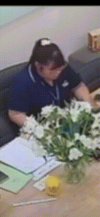 a blurry picture of a man sitting at a table with flowers