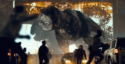 a t-rex is being projected on a wall behind a crowd of people