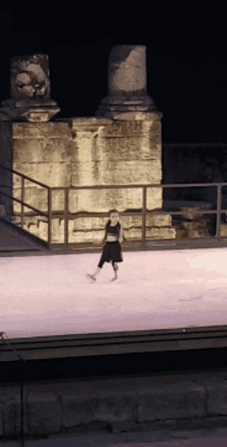 a little girl in a black dress is ice skating