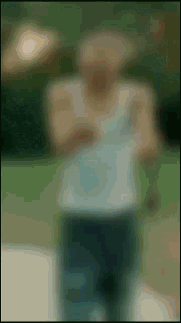 a blurry picture of a man in a white tank top with the number 3 on it