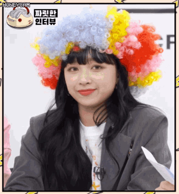 a woman wearing a clown wig with the word honeycam on the corner