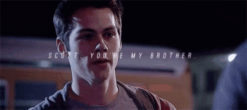 a close up of a young man 's face with the words `` scott , you 're my brother '' written on it .