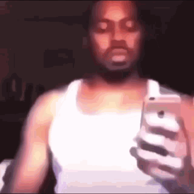 a man is taking a selfie with his phone .