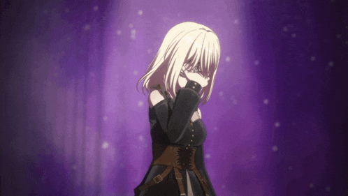 a girl with blonde hair is covering her face with her hand