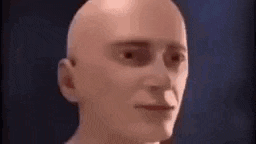 a close up of a bald man 's face with a slight smile on his face .