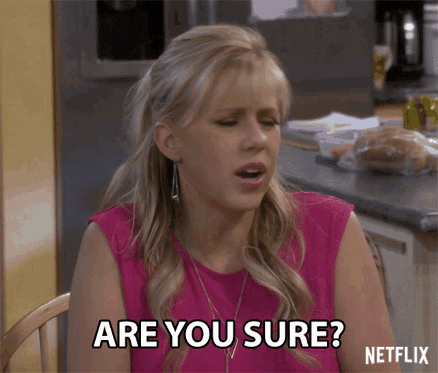 a woman in a pink shirt says " are you sure " while sitting at a table