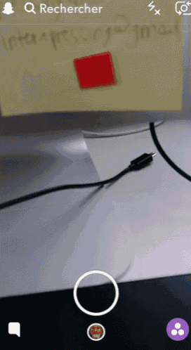 a screen shot of a snapchat app shows a red square on a yellow sticky note