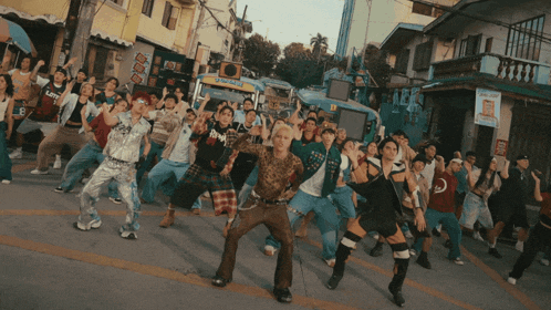 a large group of people are dancing in front of a sign that says ' jeepney '