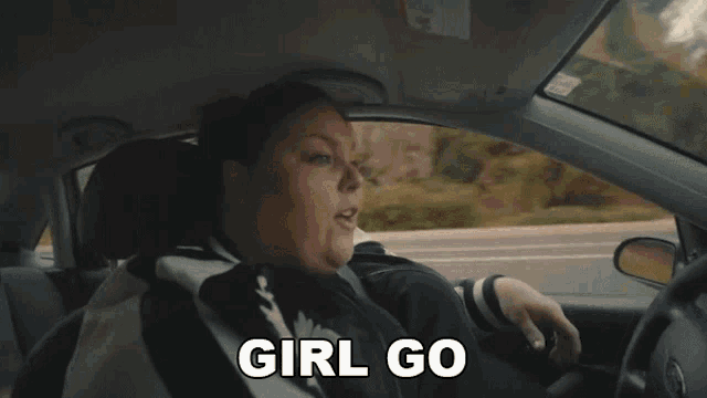 a woman in a car says " girl go " in white letters