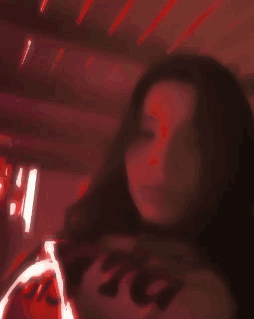 a blurry picture of a woman wearing a shirt that says ' rita '