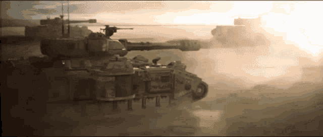 two military tanks are driving through the desert