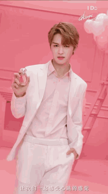 a close up of a person holding a bottle of perfume that says i do always open kiss