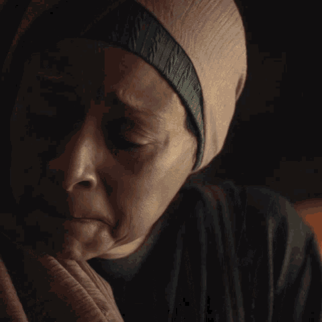 a woman with her eyes closed wearing a headband that says n on it