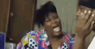 a woman is laughing while talking on a cell phone .
