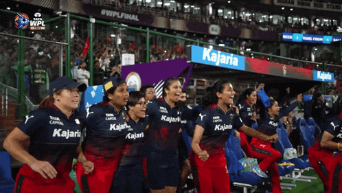 a group of women wearing kalari shirts are standing in a stadium