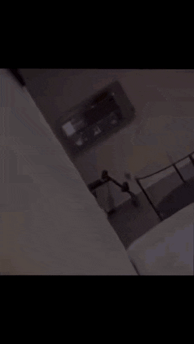 a bedroom with a bed and a ceiling fan