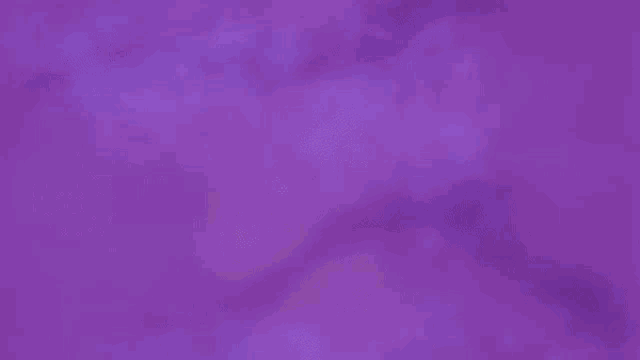 a close up of a girl 's face in a purple background