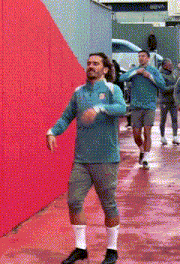 a man wearing a blue shirt with the united states on it is dancing