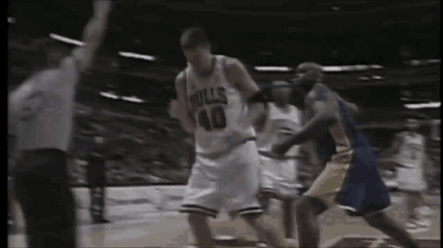 a basketball player with the number 15 on his jersey is being fouled by another player