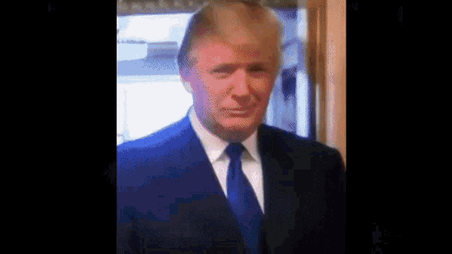 a close up of a man in a suit and tie