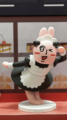 a figurine of a bunny in a maid outfit with a face drawn on it