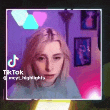a tiktok video of a woman with blonde hair is being displayed on a screen .