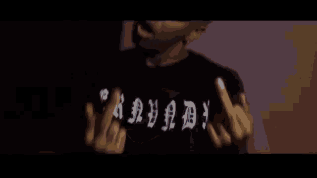 a man wearing a blue adidas hat is giving the middle finger to the camera