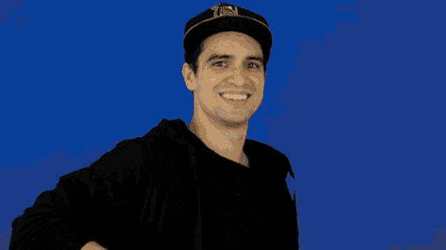 a man wearing a hat and a black shirt has a pixelated middle finger on his chest