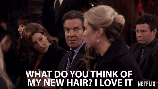 a group of people are sitting in a room with the caption what do you think of my new hair