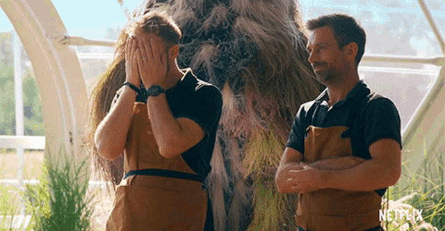 two men wearing aprons are standing in front of a netflix logo