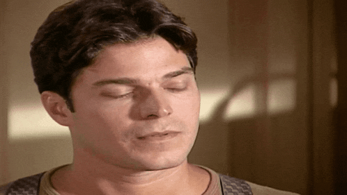a close up of a man 's face with closed eyes