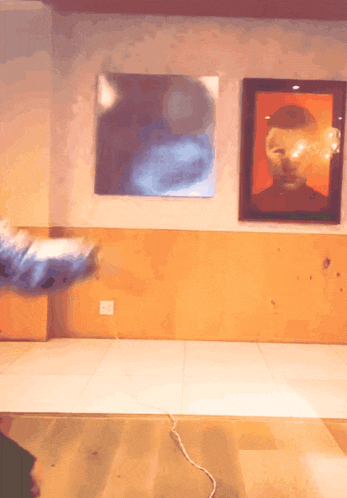 a room with a painting on the wall and a picture of a man