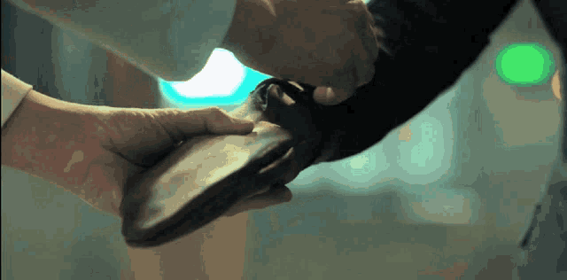 a close up of a person holding a piece of wood