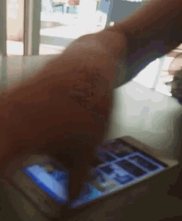 a close up of a person using a smart phone on a table